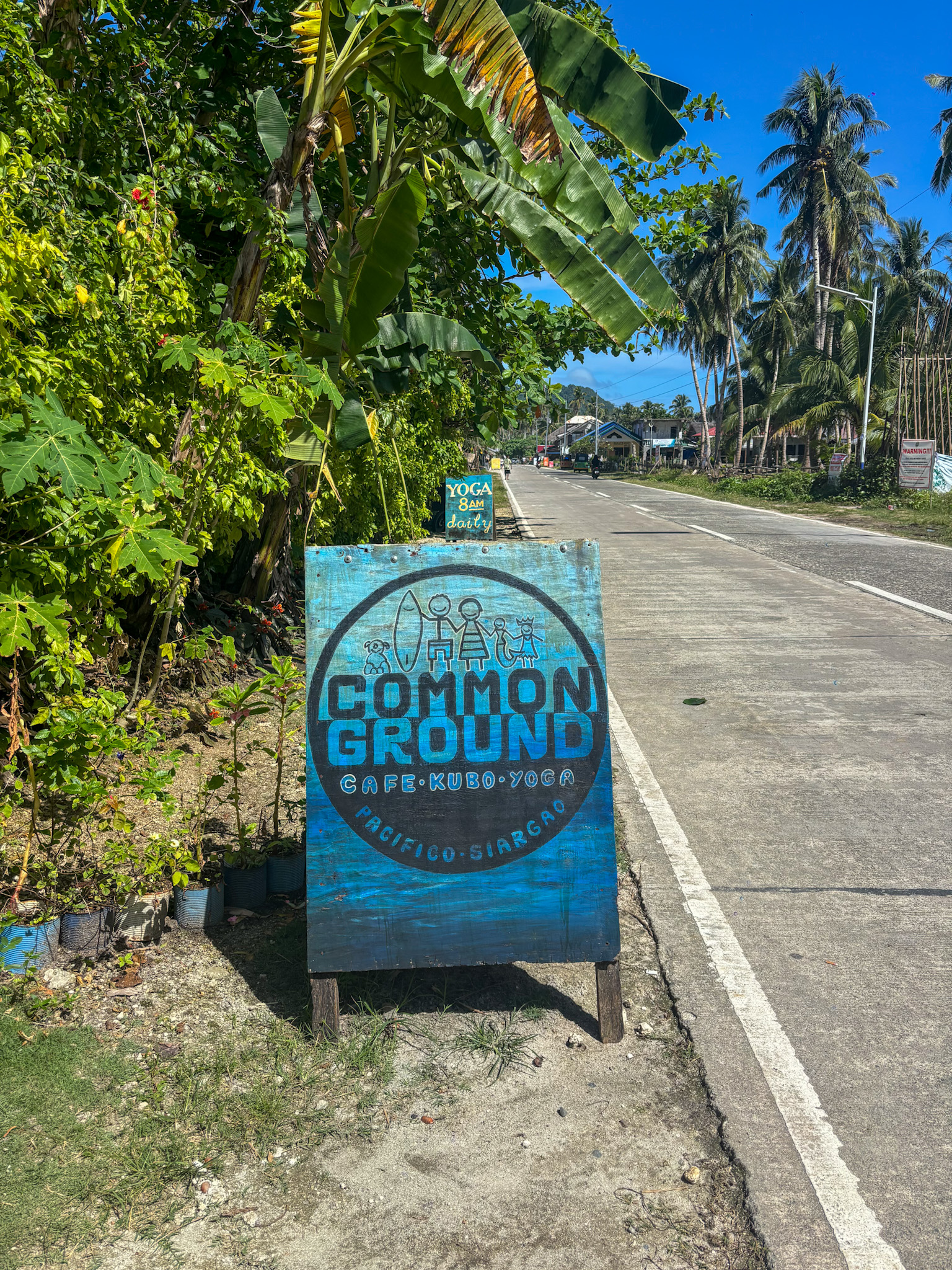 Common Ground café sign on the road in Pacifico, Siargao